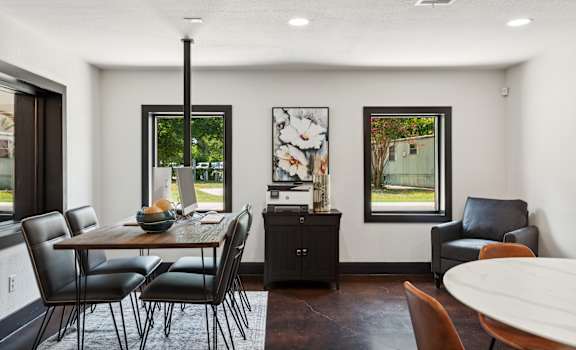 A dining room with a table and chairs.
