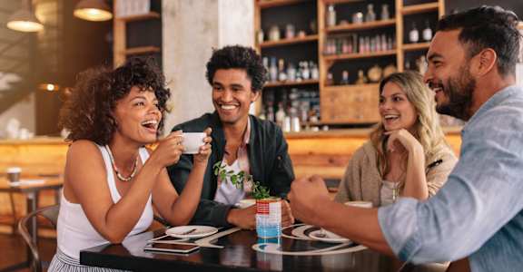 a group of people sitting at a table in a restaurant