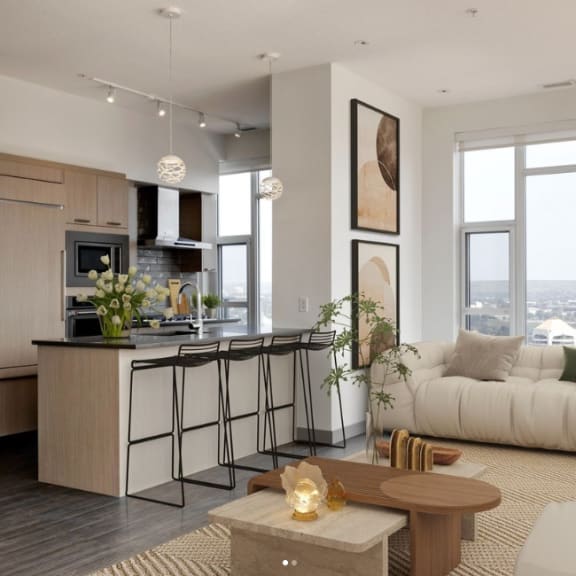 a living area with a kitchen and a couch at Versus, Calgary, Alberta