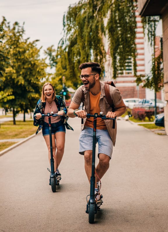 Couple on bikes on a sidewalk