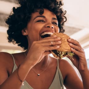 a woman eating a hamburger