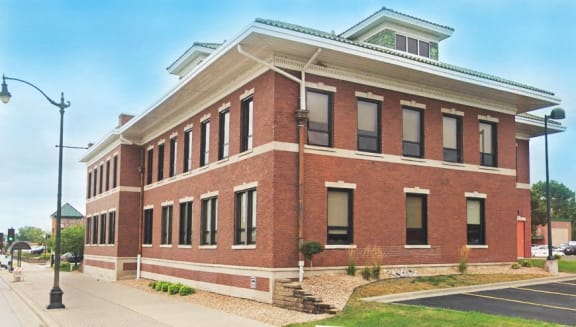 a large brick building with a street in front of it