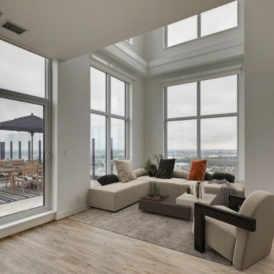 A living area with a couch and large windows at BLVD Beltline, Calgary, Alberta