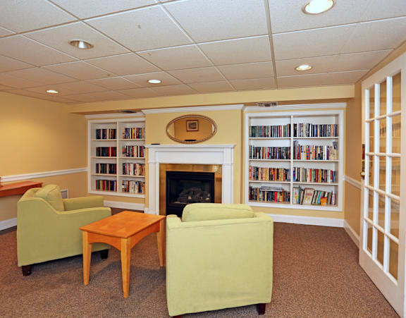 an office with a desk and chairs and a window