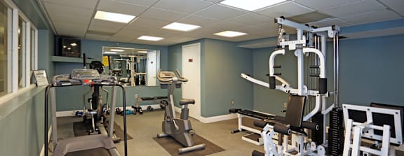 a fitness room with weights and other exercise equipment