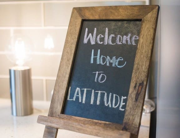 Latitude Apartments and Townhomes Welcome Home Sign