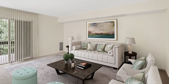 a living room with a white couch and a table  at The Commons of McLean, McLean