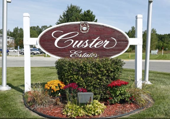 WELCOME Sign at Custer Estates Apartments, Monroe