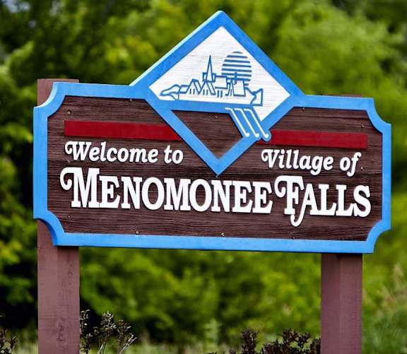 A sign welcoming visitors to the Village of Menomonee Falls.