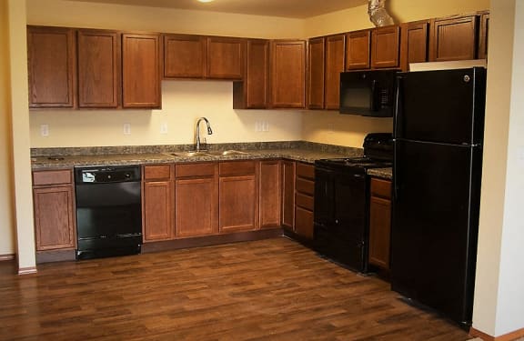 Image of refrigerator, stove, microwave, sink, cabinets, and dishwasher