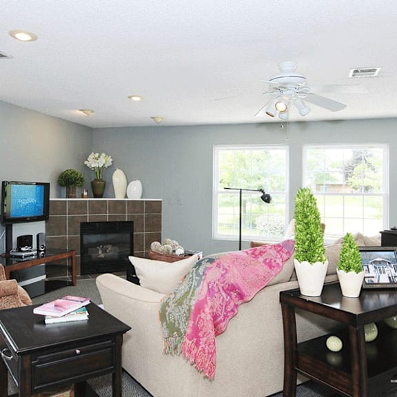 Clubhouse lounge with a fireplace and seating at Red Coach Village in Springfield, OH