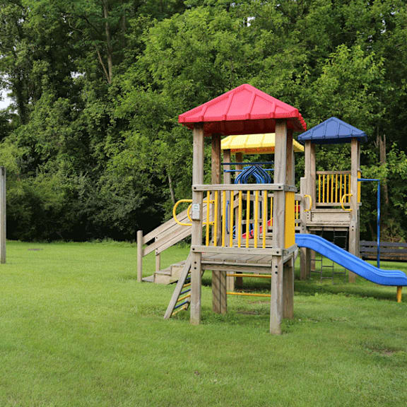 Playground on a grassy lawn at Red Coach Village in Springfield, OH