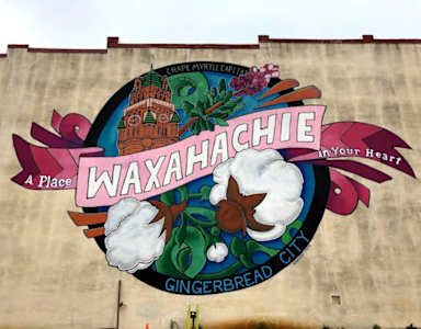 A mural on a wall that says Waxahachie.