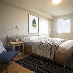 a bedroom with a bed and a chair and a table