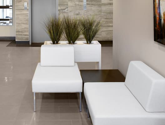 Lobby With White Couches and Plants
