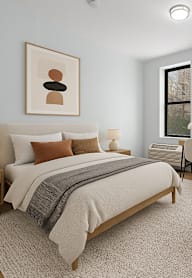 A bedroom with a large bed and a couch.