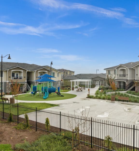 a playground is in the middle of an empty park
