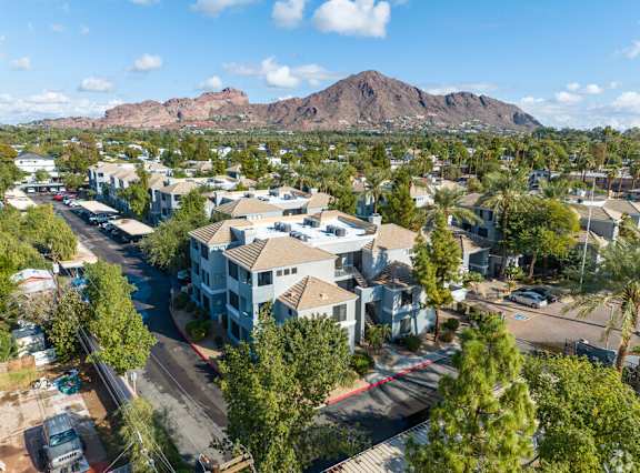 A bird's eye view of a residential area with houses and trees.