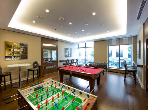 a game room with a foosball table and a ping pong table