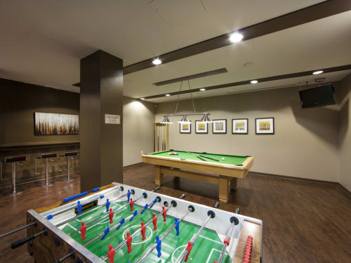 a games room with a foosball table and a ping pong table