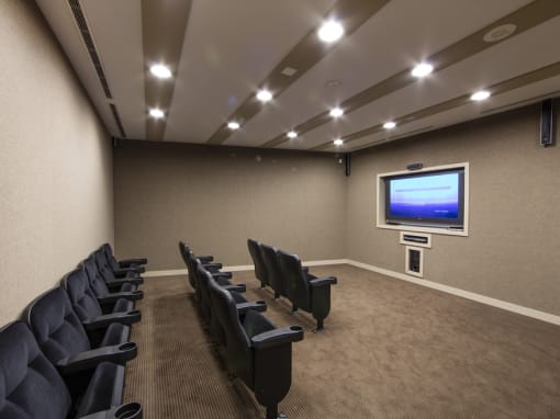 a small conference room with a projector screen and chairs