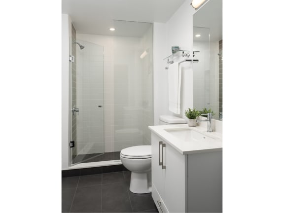 a bathroom with a toilet sink and shower