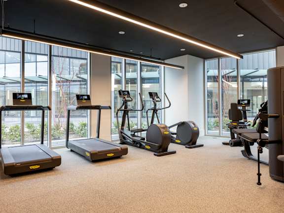 a gym with treadmills and other exercise equipment