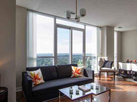 a living room filled with furniture and a large window