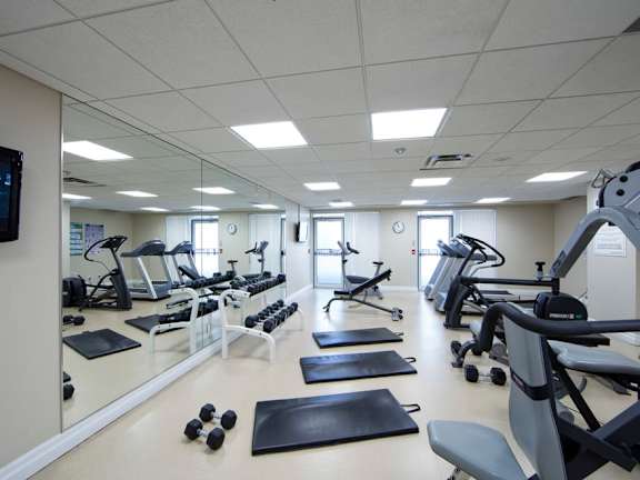 a fitness center with treadmills and other exercise equipment