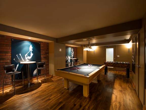 a game room with a pool table and a foosball table
