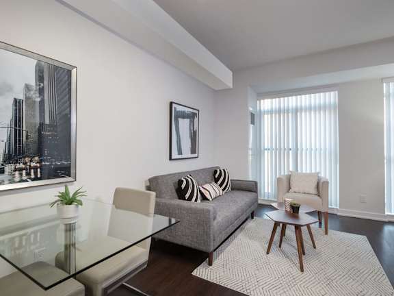 a living room with a couch and a glass table