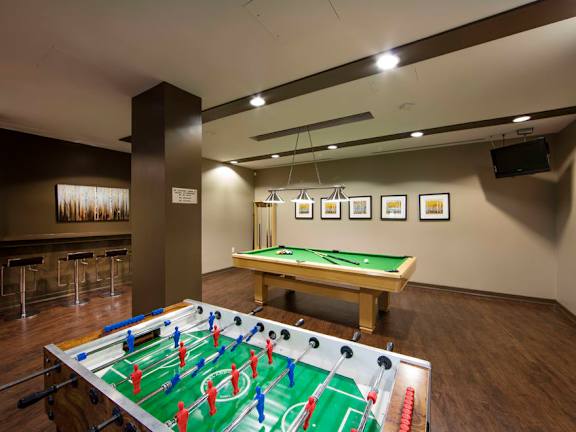 a games room with a foosball table and a ping pong table