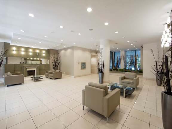 a lobby with couches and chairs and a fireplace