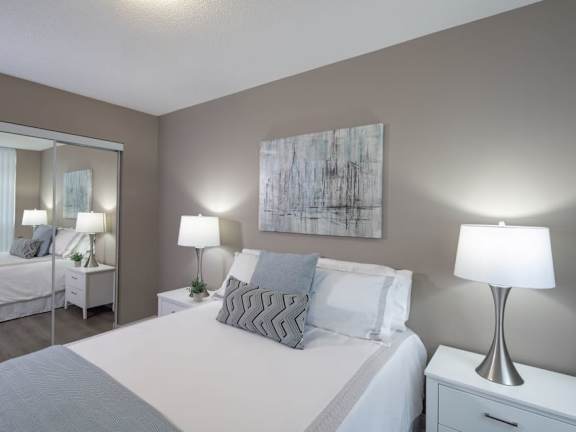 a bedroom with a bed and a mirror