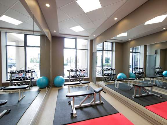 a fitness center with yoga mats and exercise equipment