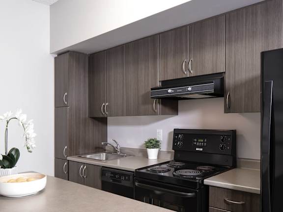 a kitchen with a stove top oven next to a sink