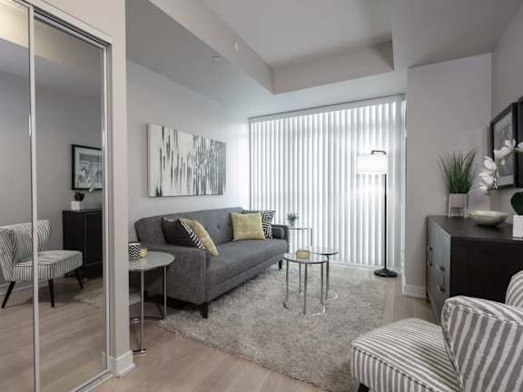 a living room filled with furniture and a large window