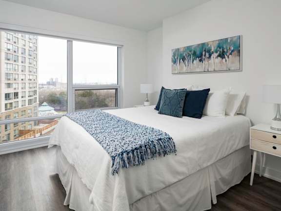 a bedroom with a large bed and a large window