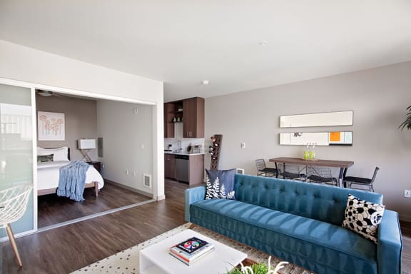 a living room with a blue couch and a coffee table