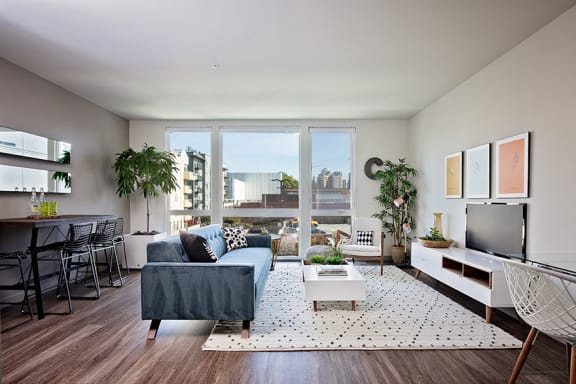 a living room with a large window and a view of the city