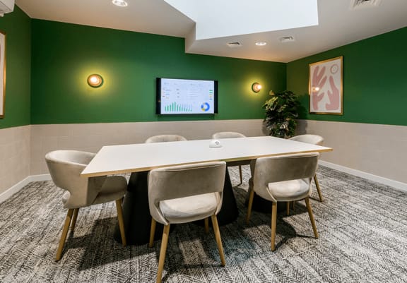 a conference room with a wooden table and chairs