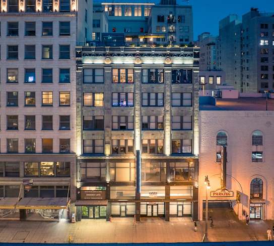 a view of a building from above on a city street at night