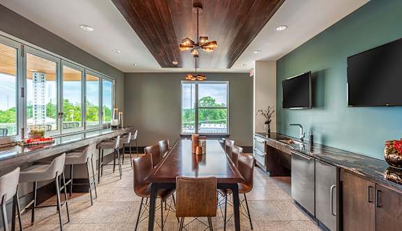 A modern dining room with a wooden table and chairs.
