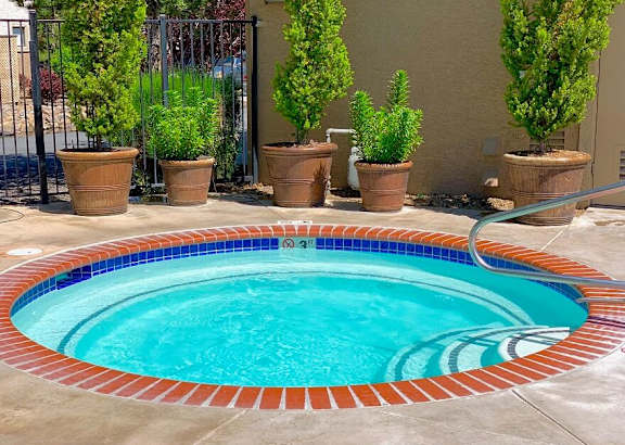 A small round spa area with a tiled edge at Sharlands Terrace Apartments, Apartments, Reno, NV