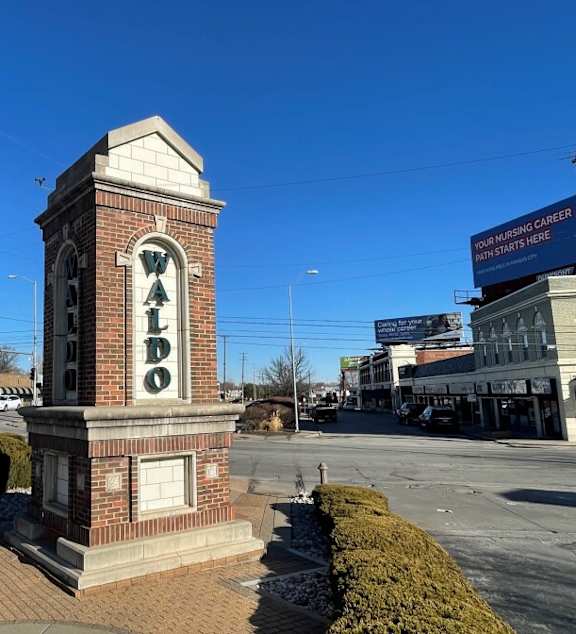 a building with a lawn and a sign in front of it
