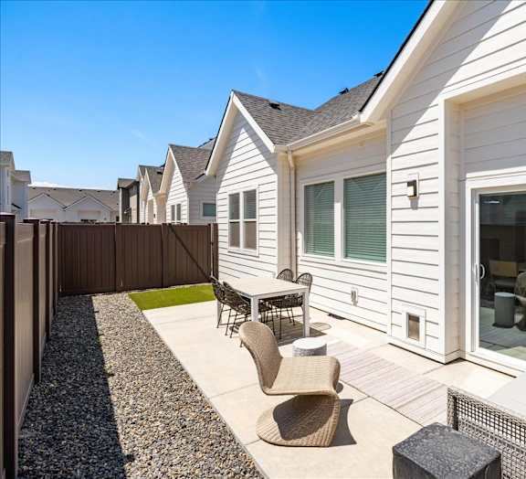A white house with a patio furniture set.at Alante Homes at Spring Run, Idaho