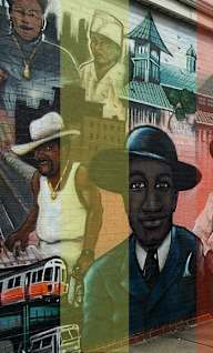 A mural on a wall with a man in a hat as the central figure.