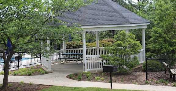 a gazebo in a park with benches