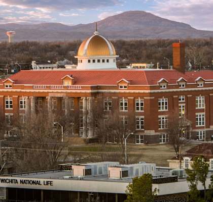 A large building with a golden dome is the main focus of the image.