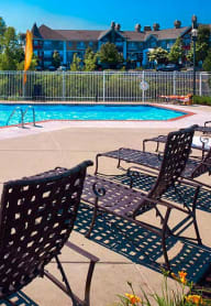 a swimming pool with chairs next to it